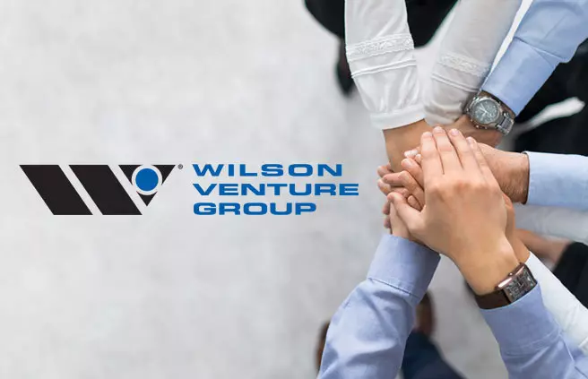 Acercamiento de manos apiladas con el logo de Wilson Venture Group en la esquina inferior