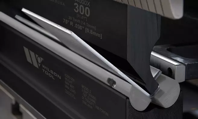 closeup of small metal piece being bent with a VSB die