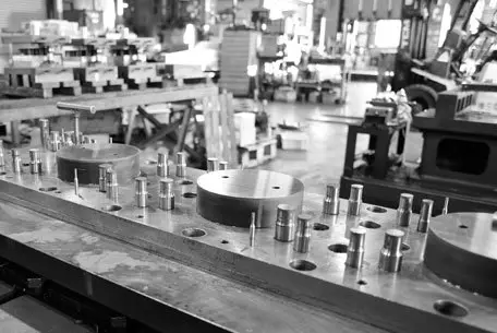 black and white photo of progress stamping press setup