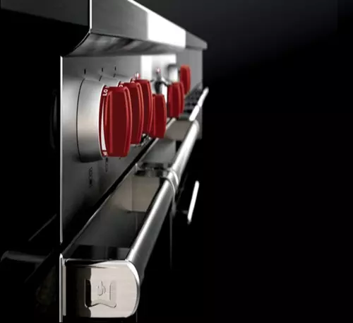 Close Up Image of Red Dials on a Stainless Steel Commercial Oven