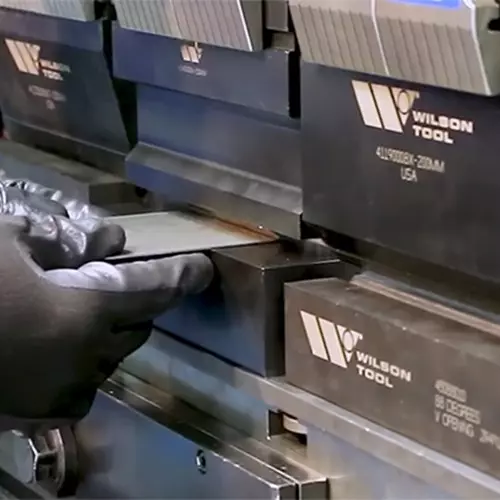 Press brake bending metal in a staged setup image