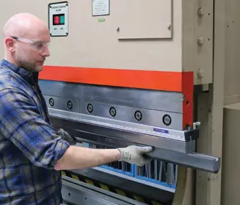 worker replacing a dove style replaceable radius press brake punch tip